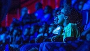 Young girl gasps in delight as she experiences a show in the in the 4D theater audience at the State Museum.