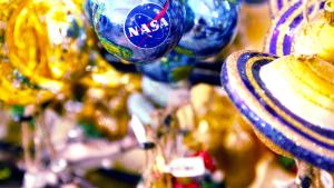 Round Blue NASA Ornament and Blue and Gold Saturn Planet Ornaments On Display