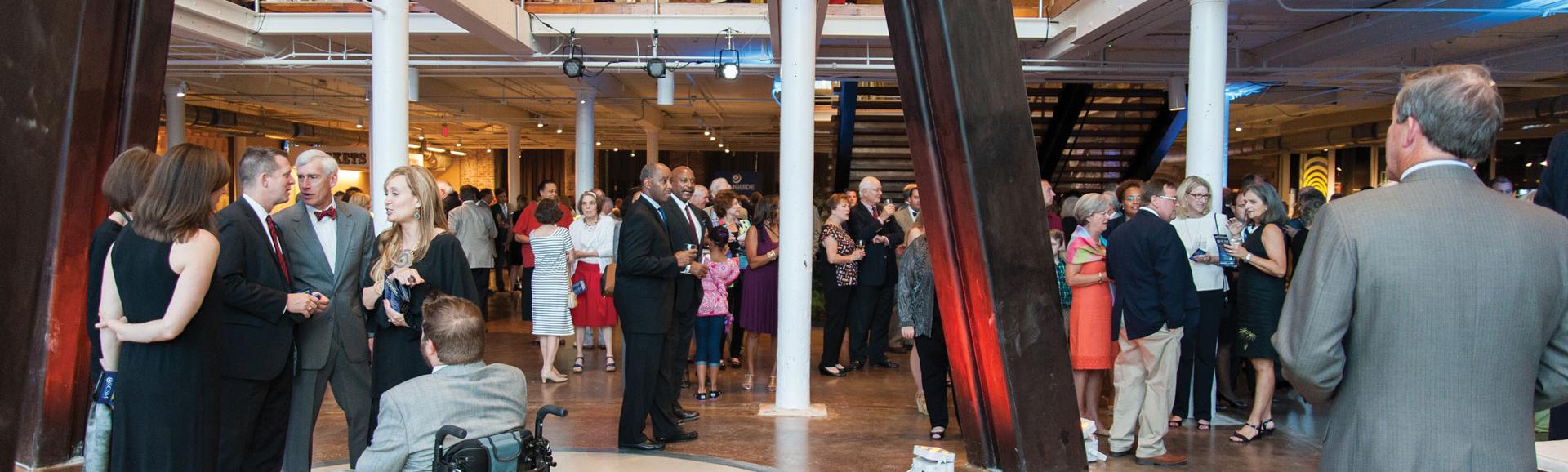 Events guests mill about around the iconic telescope legs at the South Carolina State Museum.