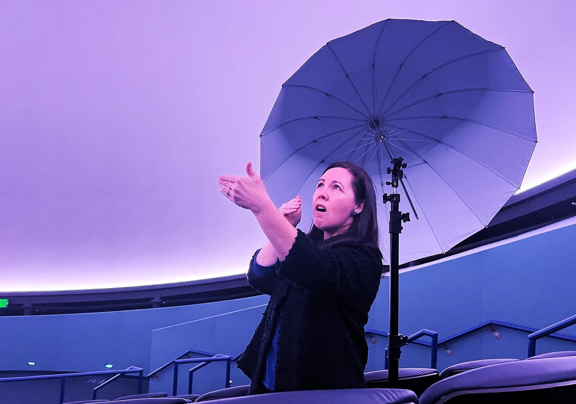 Guide presents ASL interpretation during planetarium show