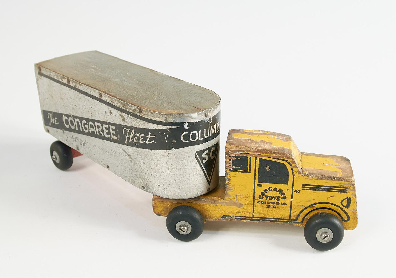 A toy truck with a yellow can and a trailer that says Congaree Fleet