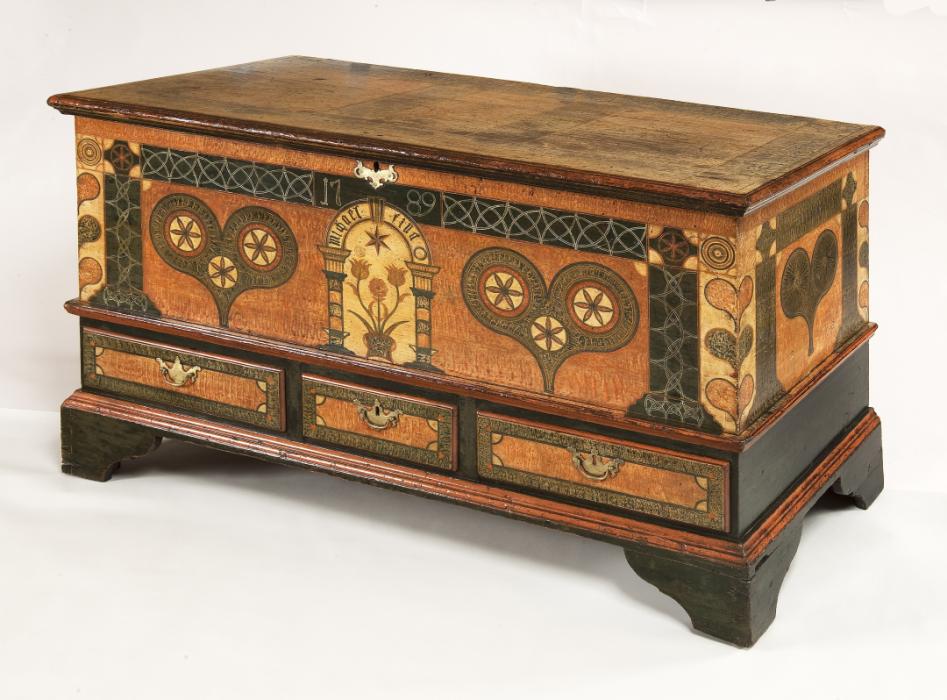 large wooden chest with intricate inlaid designs on the front and sides